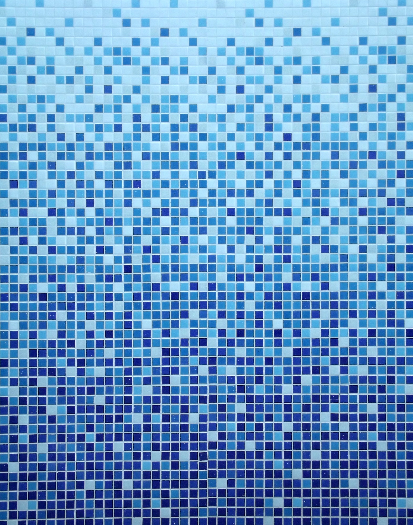 Blue tiled wall of a swimming pool